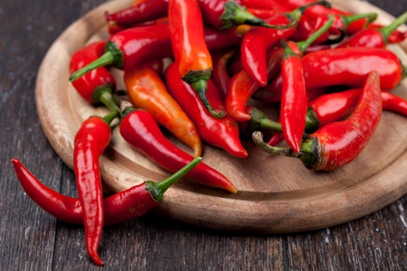 Fresh red pepper on a wooden tableの写真素材