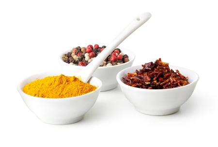 Spices Curry, Peppers Mix and paprika in ceramic bowl on a white backgroundの写真素材