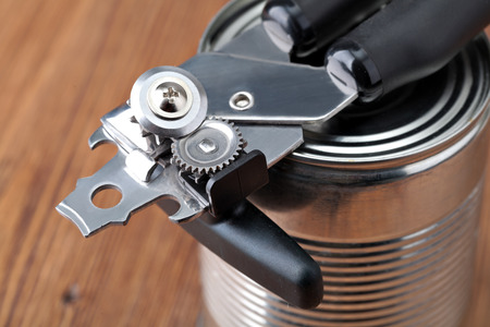 Tin opener opening a canの写真素材