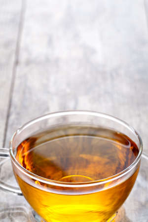 Cup of tea on a wooden backgroundの写真素材