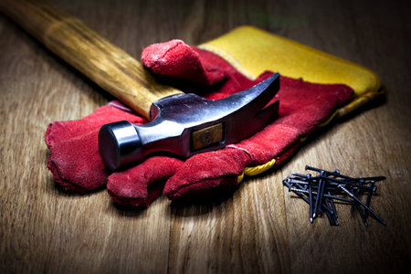 Construction gloves and hammer on a white backgroundの写真素材