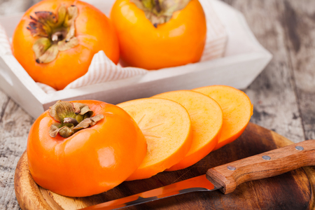 persimmons on wooden backgroundの写真素材