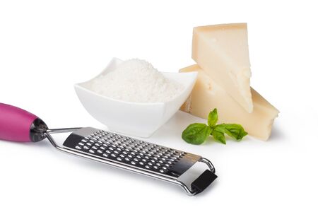 grated parmesan cheese and metal grater on white backgroundの写真素材