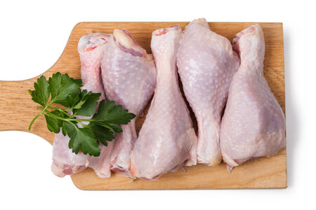 Pieces of raw chicken meat on a white backgroundの写真素材
