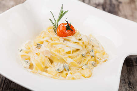 pasta with dorblue cheese on a white plateの写真素材