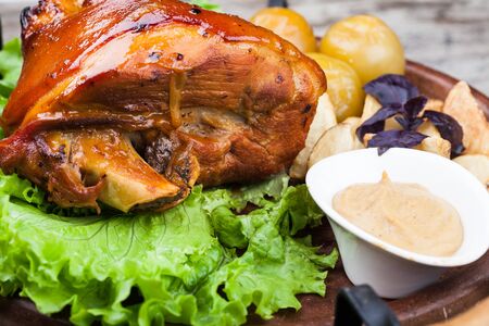 Appetizing roast pork knuckle on cutting boardの写真素材