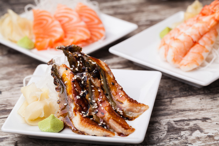 delicious mixed sashimi on a black plateの写真素材