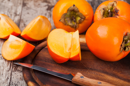 persimmons on wooden backgroundの写真素材