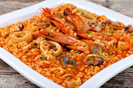 Spanish paella, rice with seafood on white plate. Close-upの写真素材