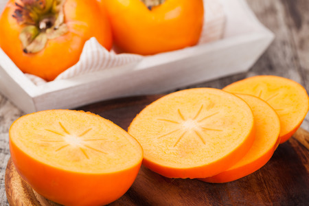 persimmons on wooden backgroundの写真素材