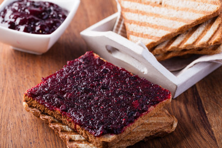 Toast with jam on a wooden table