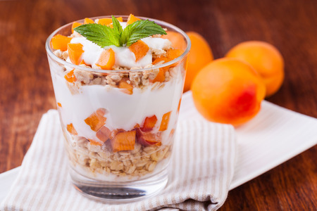 yogurt with muesli and berries on a wooden tableの写真素材