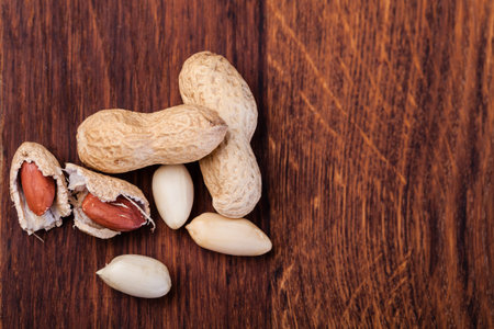 Peanuts isolated on a wooden table