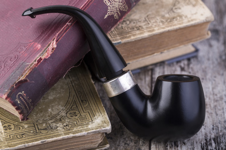Smoking pipe on a wooden tableの写真素材