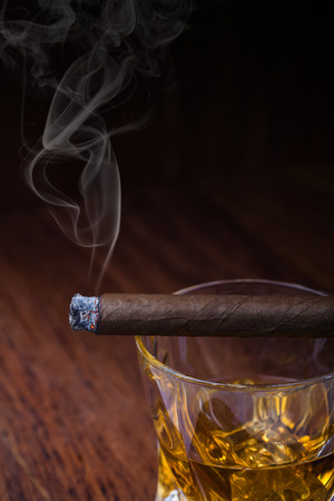 Whiskey and cigar on wooden backgroundの写真素材