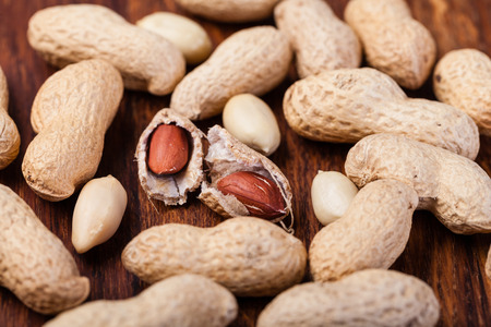 Peanuts isolated on a wooden tableの写真素材