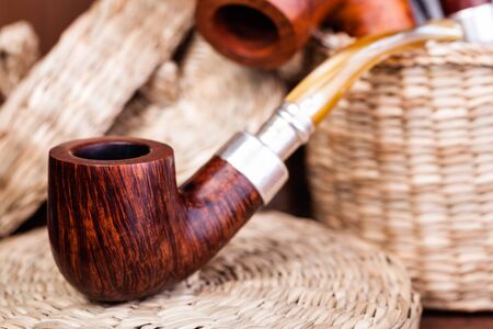 Smoking pipe on a wooden tableの写真素材