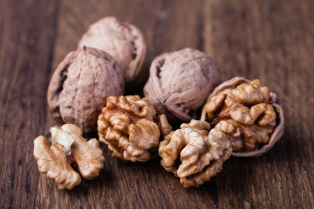 walnuts isolated on a wooden tableの写真素材