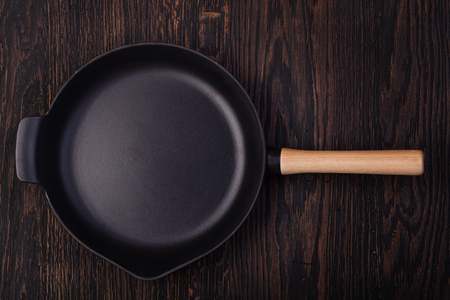 iron frying pans rustic wood background.の写真素材