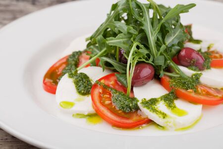 fresh Caprese Salad on a white dishの写真素材