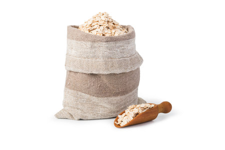Oatmeal flakes in the bag isolated on white backgroundの写真素材