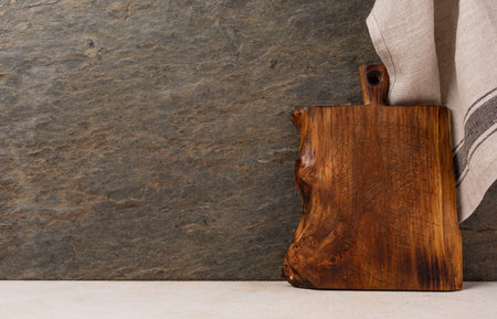 Rustic wooden cutting board on rusty stone background