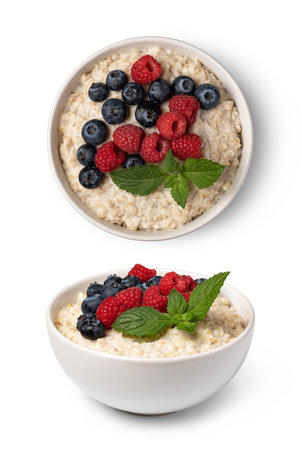 prepared oatmeal with berries isolated on white backgroundの写真素材
