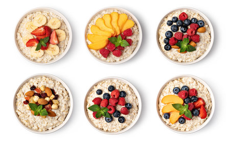 prepared oatmeal with fruits and berries isolated on white backgroundの写真素材
