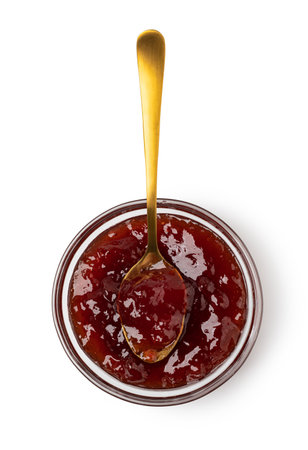 spoon on the saucer with jam isolated on whiteの写真素材