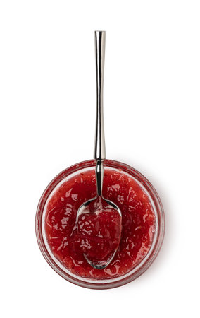 spoon on the saucer with jam isolated on whiteの写真素材