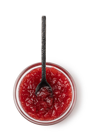 spoon on the saucer with jam isolated on whiteの写真素材