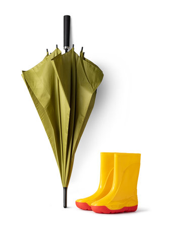 green umbrella and gumboots on white backgroundの写真素材