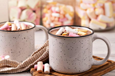 Hot chocolate with marshmallow in a cup on wooden backgroundの写真素材