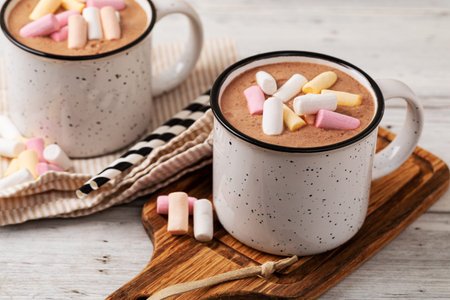 Hot chocolate with marshmallow in a cup on wooden background