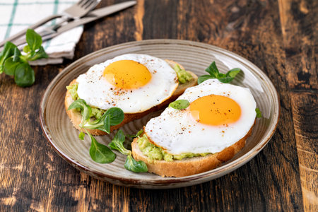toast with fried egg on a wooden table