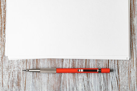 Blank paper with mechanical pencil on wood table
