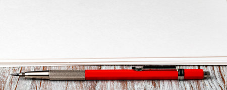 Blank paper with mechanical pencil on wood tableの写真素材