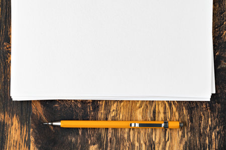Blank paper with mechanical pencil on wood tableの写真素材