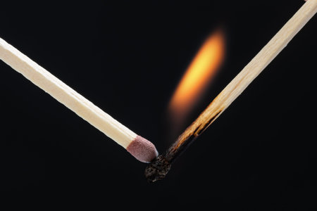 Match burning on a black background