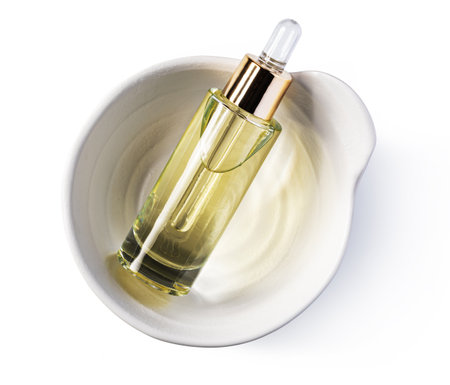 Essential serum Oil in cosmetic bottles with dropper isolate on white backgroundの写真素材