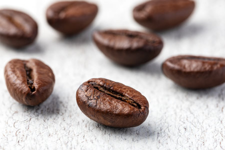 roasted coffee beans on a wooden background.の写真素材