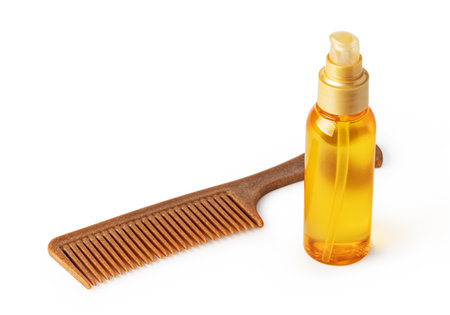 dispenser bottle and hair comb isolated on white backgroundの写真素材