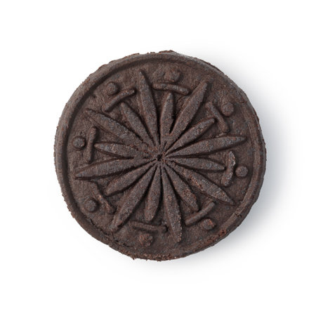 Chocolate cookies with a decorative radial pattern are lying on a white backgroundの写真素材