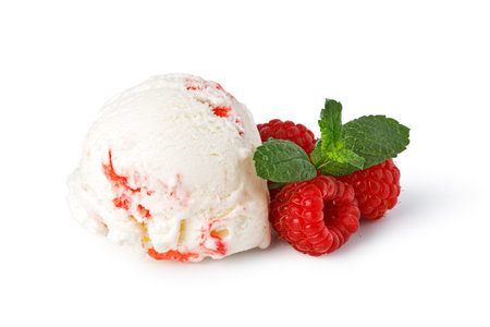 Creamy raspberry ice cream scoop decorated with fresh raspberries and mint leaves on a white backgroundの写真素材