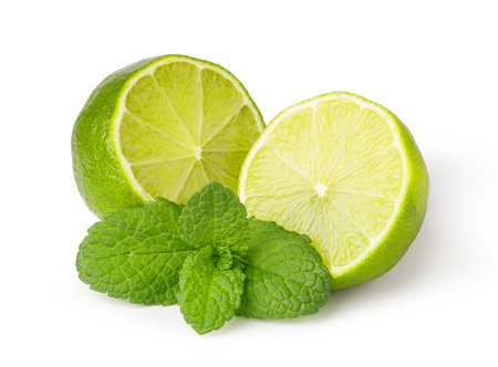 Two juicy lime halves and fresh mint leaves create a refreshing image on a clean white backgroundの写真素材