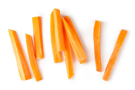 Freshly cut carrot sticks arranged on a white background, creating an interesting visual for healthy eating and vegan lifestylesの写真素材