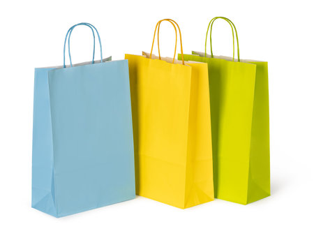 Vibrant paper shopping bags stand ready for purchases, symbolizing consumerism and retail therapyの写真素材