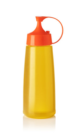 Studio shot of a plastic squeeze bottle containing cooking oil, isolated on a white background with slight reflectionの写真素材