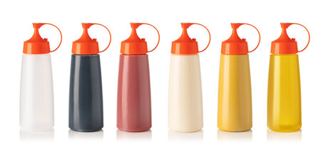 Set of colorful plastic squeeze bottles filled with common condiments isolated on white backgroundの写真素材