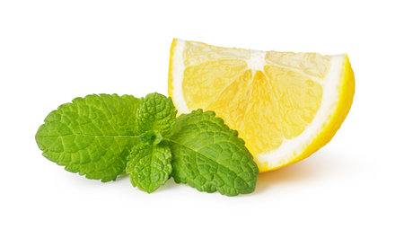 Two juicy lemon slices with fresh mint leaves isolated on white background create a refreshing imageの写真素材